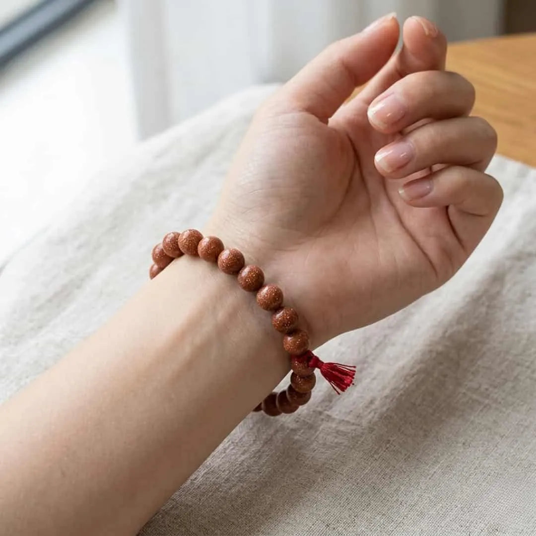 Hand wearing natural Sunstone bracelet 8mm for confidence, luck and stylish daily wear